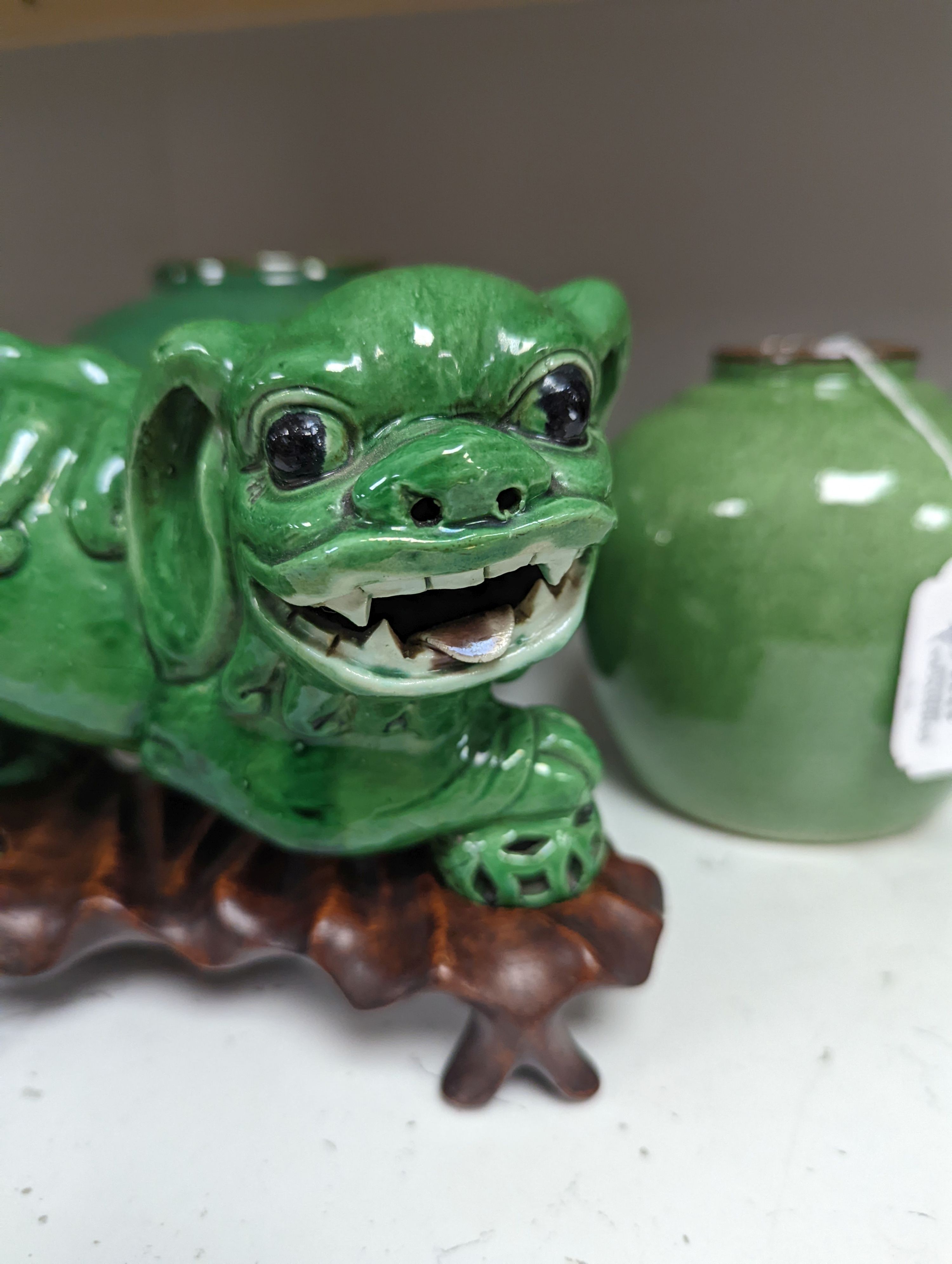 A 19th century Chinese green glazed model of a lion-dog, and two green crackle glaze jars, tallest 16cm